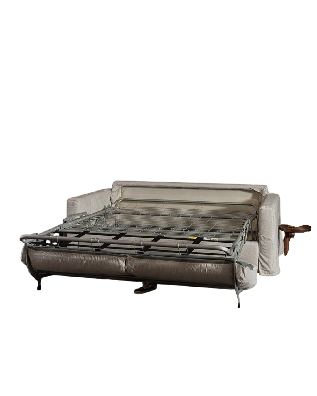 Canapé convertible Merci Paris déplié avec structure métallique apparente et revêtement en tissu beige