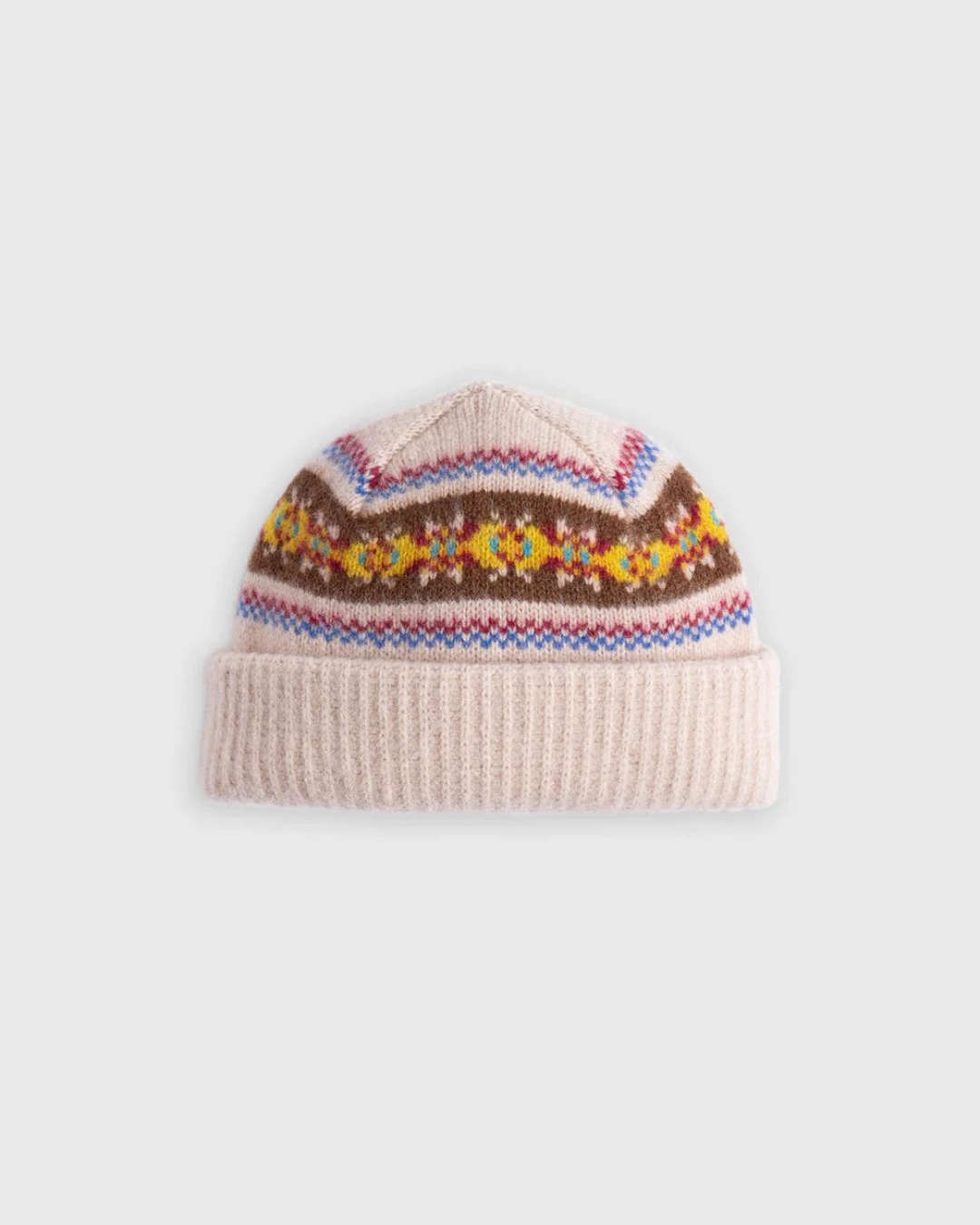Bonnet Merci Paris Howlin' en laine d'agneau couleur avoine avec motifs graphiques colorés et revers côtelé