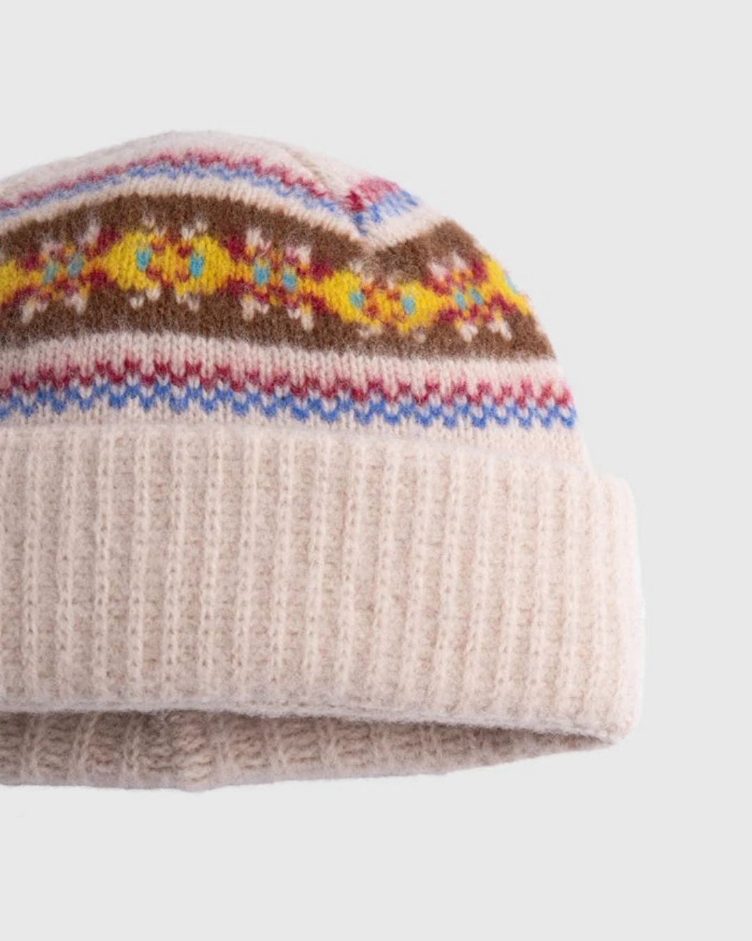 Bonnet Merci Paris Howlin' en laine d'agneau avoine avec motifs graphiques colorés et revers en maille côtelée