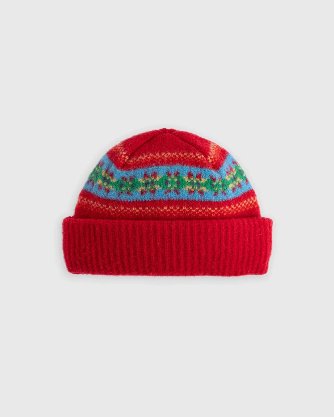 Bonnet Merci Paris Howlin' en laine d'agneau rouge avec motifs graphiques colorés et revers en maille côtelée