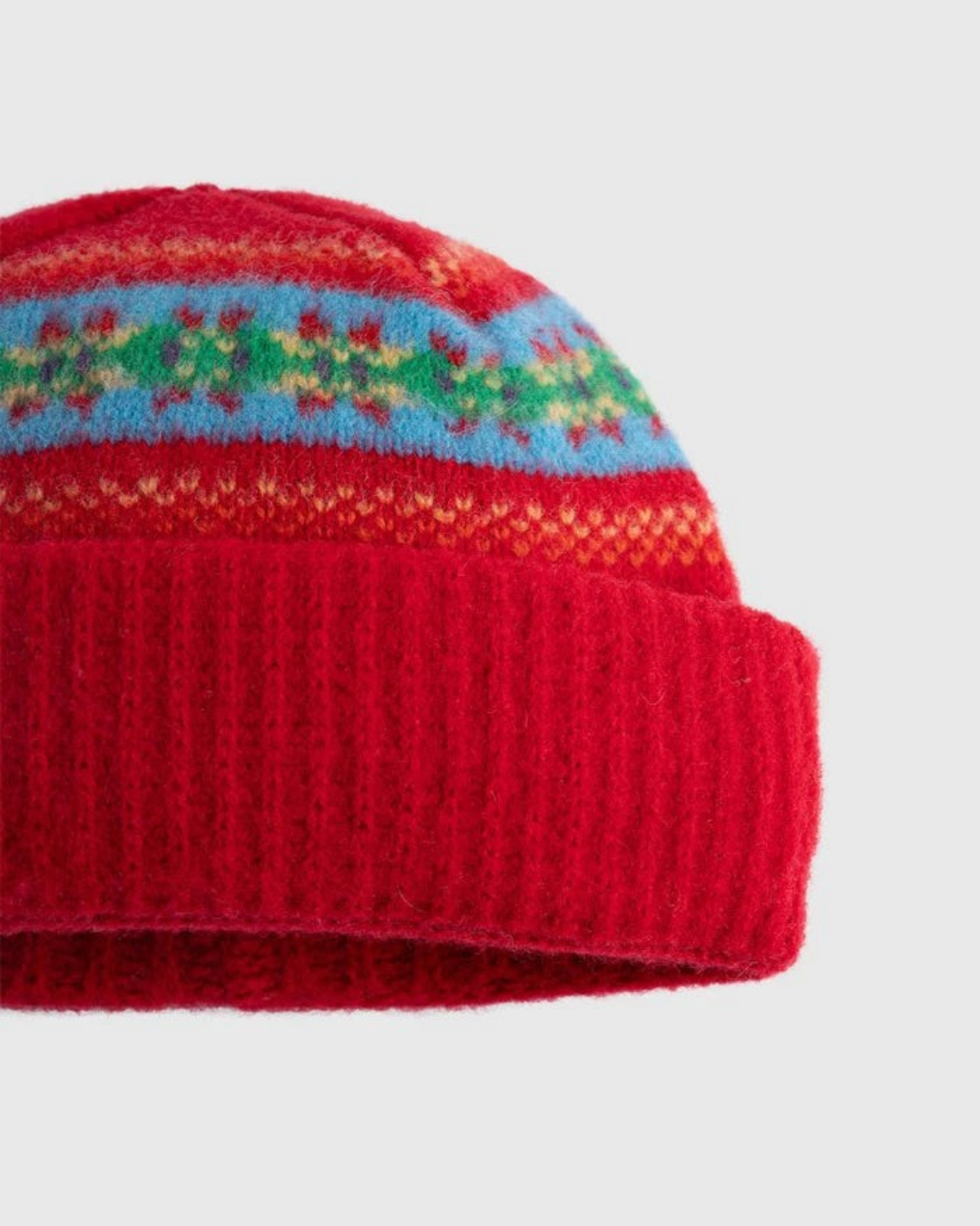 Bonnet Merci Paris Howlin en laine d'agneau rouge avec motifs graphiques colorés et revers en maille côtelée
