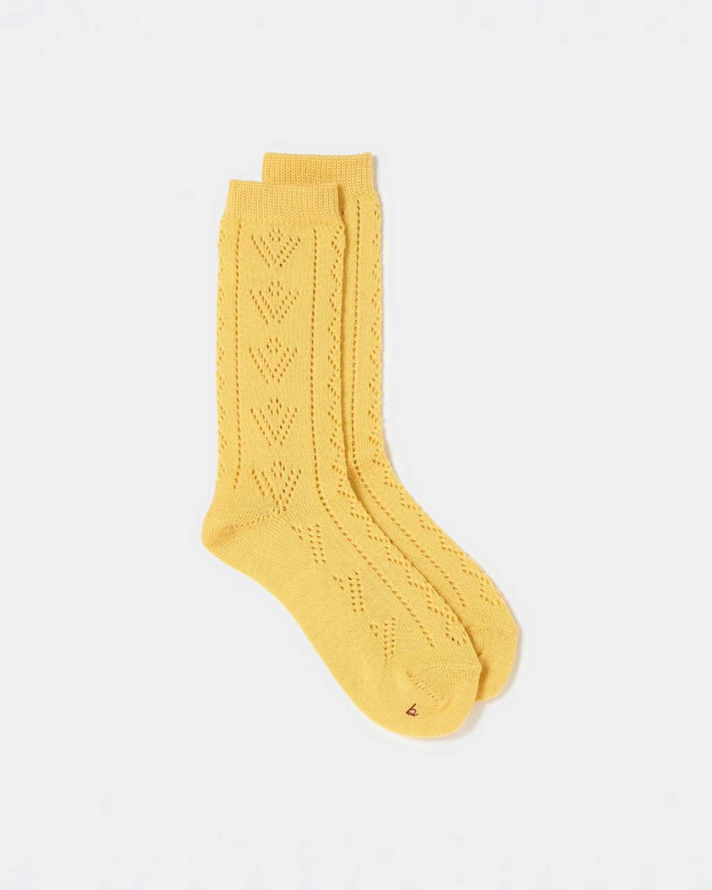 Chaussettes Merci Paris Babaco en laine jaune avec motif ajouré délicat, fabriquées au Japon