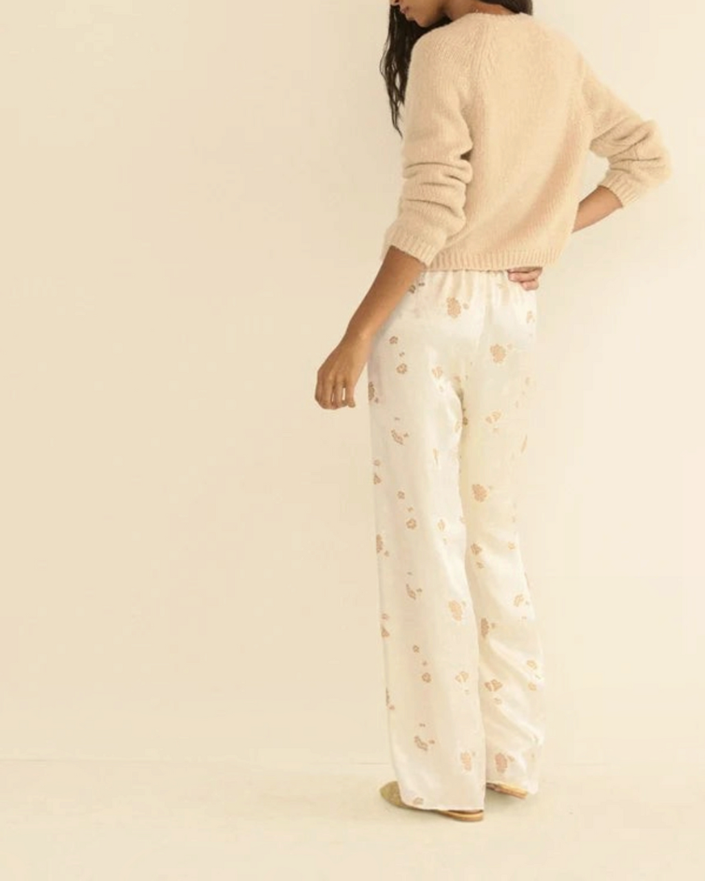 Beige Darcy cardigan in wool and cashmere Merci Paris worn by a woman with flowing patterned pants
