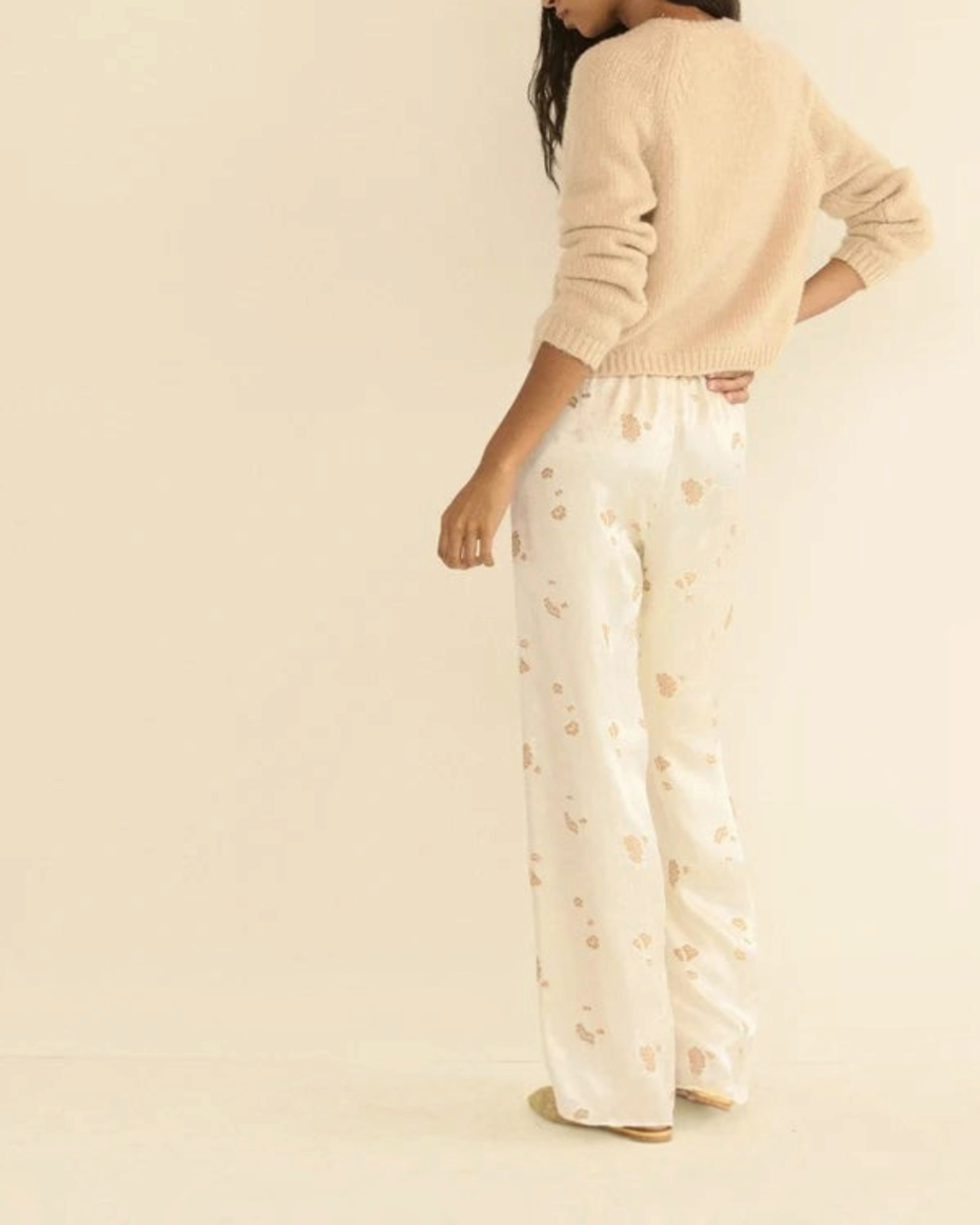 Beige Darcy cardigan in wool and cashmere Merci Paris worn by a woman with flowing patterned pants