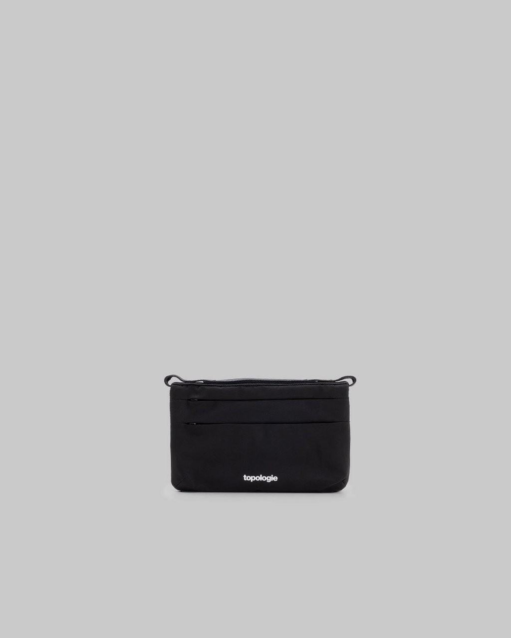 Sacoche de téléphone noire compacte Topologie par Merci Paris avec poches zippées pour accessoires urbains