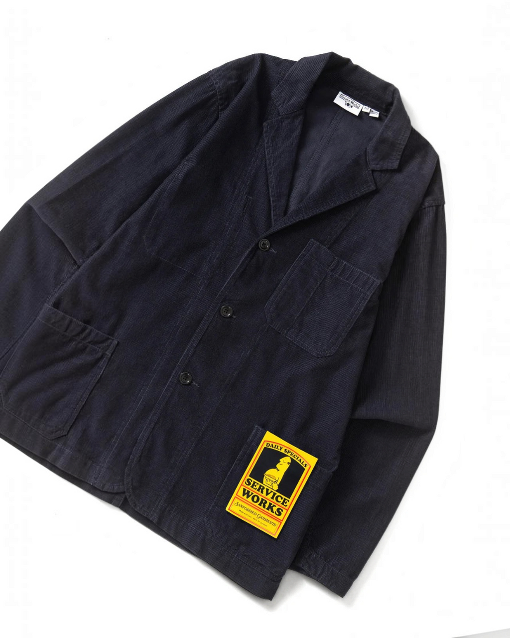 Veste Merci Paris Service Works en velours côtelé bleu marine avec trois poches et étiquette jaune distinctive